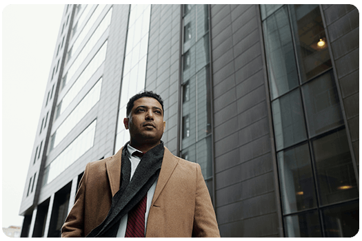 Professional man in formal attire outside a building.