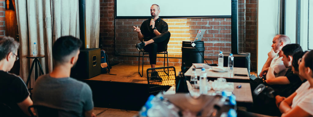 A man presenting to a group of people, engaging them with his informative and captivating presentation.
