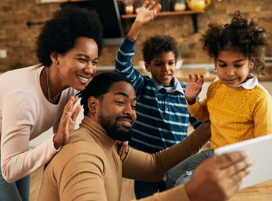 A happy family watching content on a tablet, bonding over the digital device.